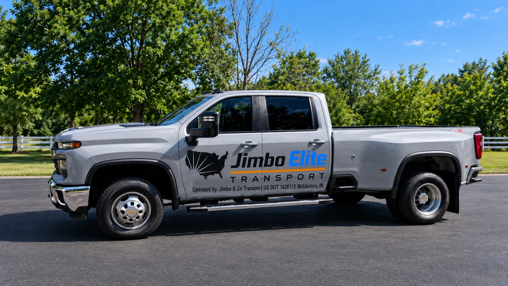 Silver Chevrolet Silverado dually pickup with Jimbo Elite Transport door graphics, operated by Jimbo & Co Transport, US DOT 1826115, Middlebury, Indiana